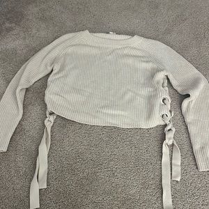 cream cropped sweater with ties on the bottom